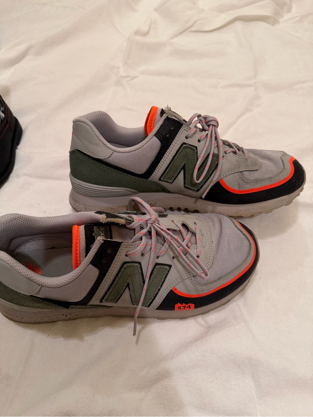 New Balance 574 Men's Sneakers in Gray with Olive and Orange Accents Rain Cloud